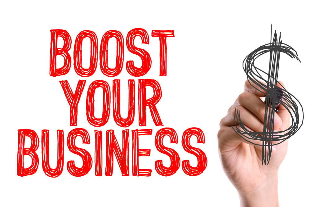 Hand with marker writing Boost Your Business